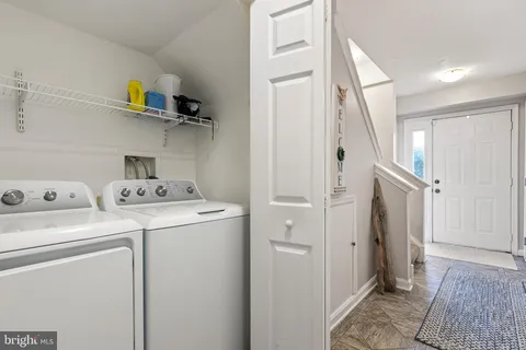a view of storage and utility room with washer and dryer