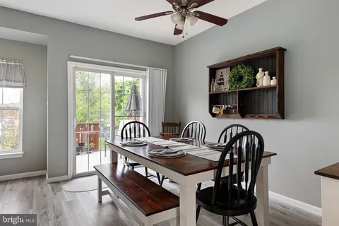 a view of a a dining room with furniture window and wooden floor