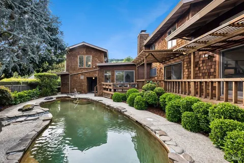 an aerial view of a house with a yard basket ball court and outdoor seating