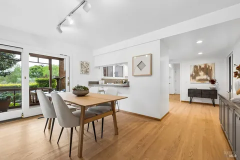 a view of a dining room with furniture and wooden floor