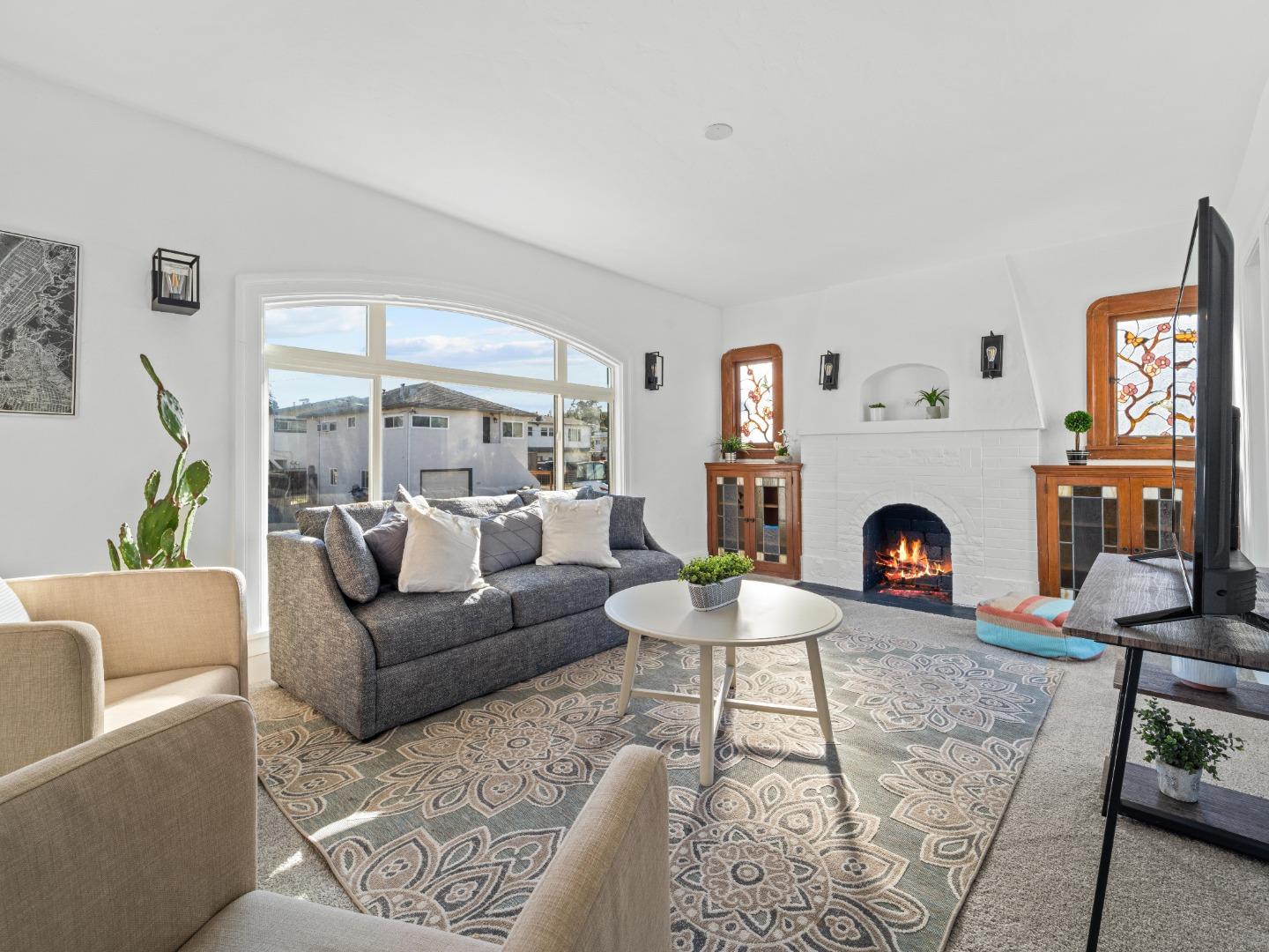 524 Fourth Street Rodeo, CA 94572 - Photo 15 of 36 a living room with furniture a rug and a fireplace