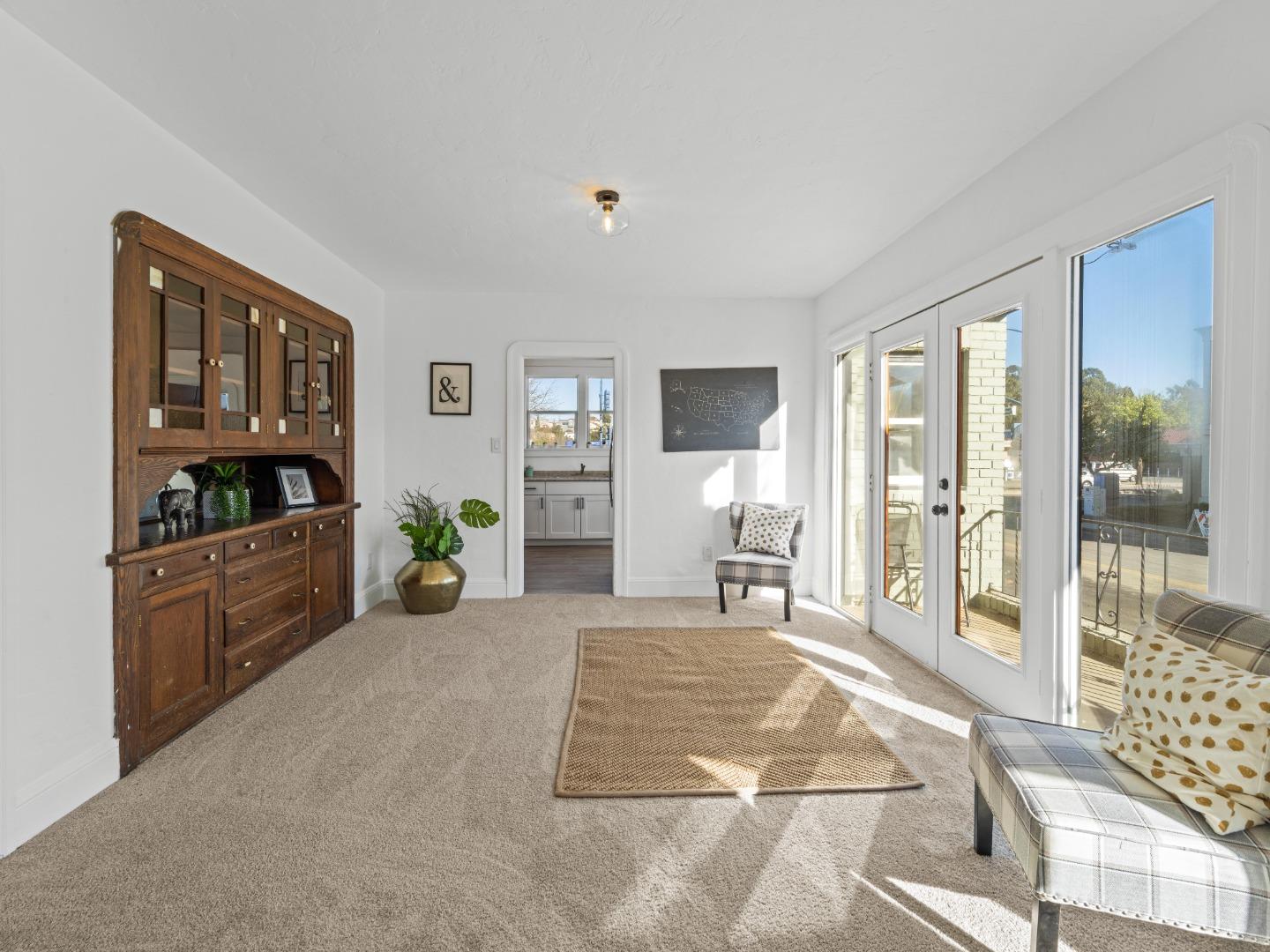 524 Fourth Street Rodeo, CA 94572 - Photo 16 of 36 a living room with furniture a flat screen tv and large window