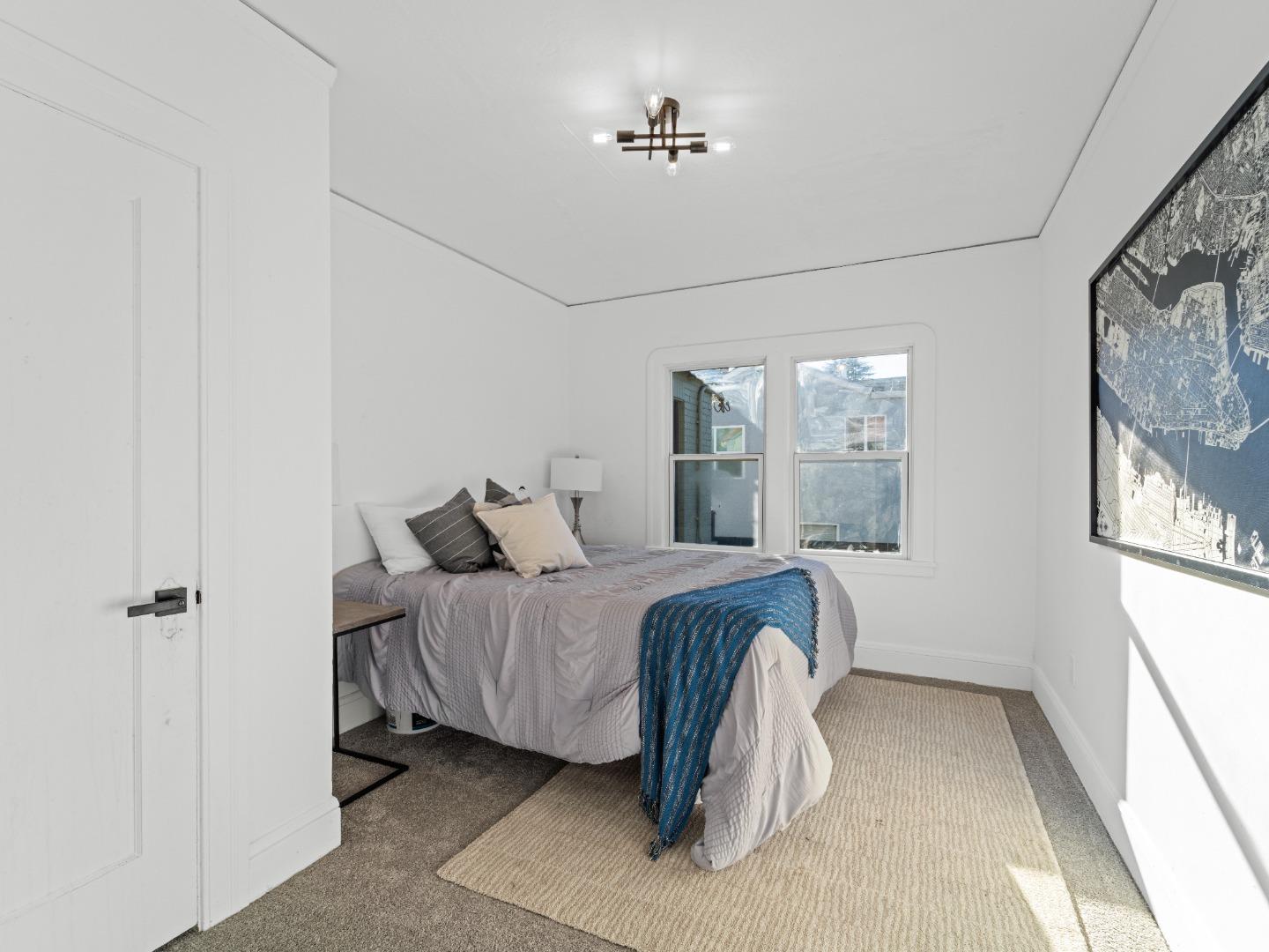 524 Fourth Street Rodeo, CA 94572 - Photo 27 of 36 a bedroom with a bed mirror and window