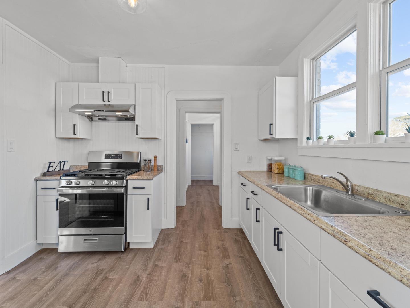 524 Fourth Street Rodeo, CA 94572 - Photo 7 of 36 a kitchen with stainless steel appliances granite countertop a stove and a sink