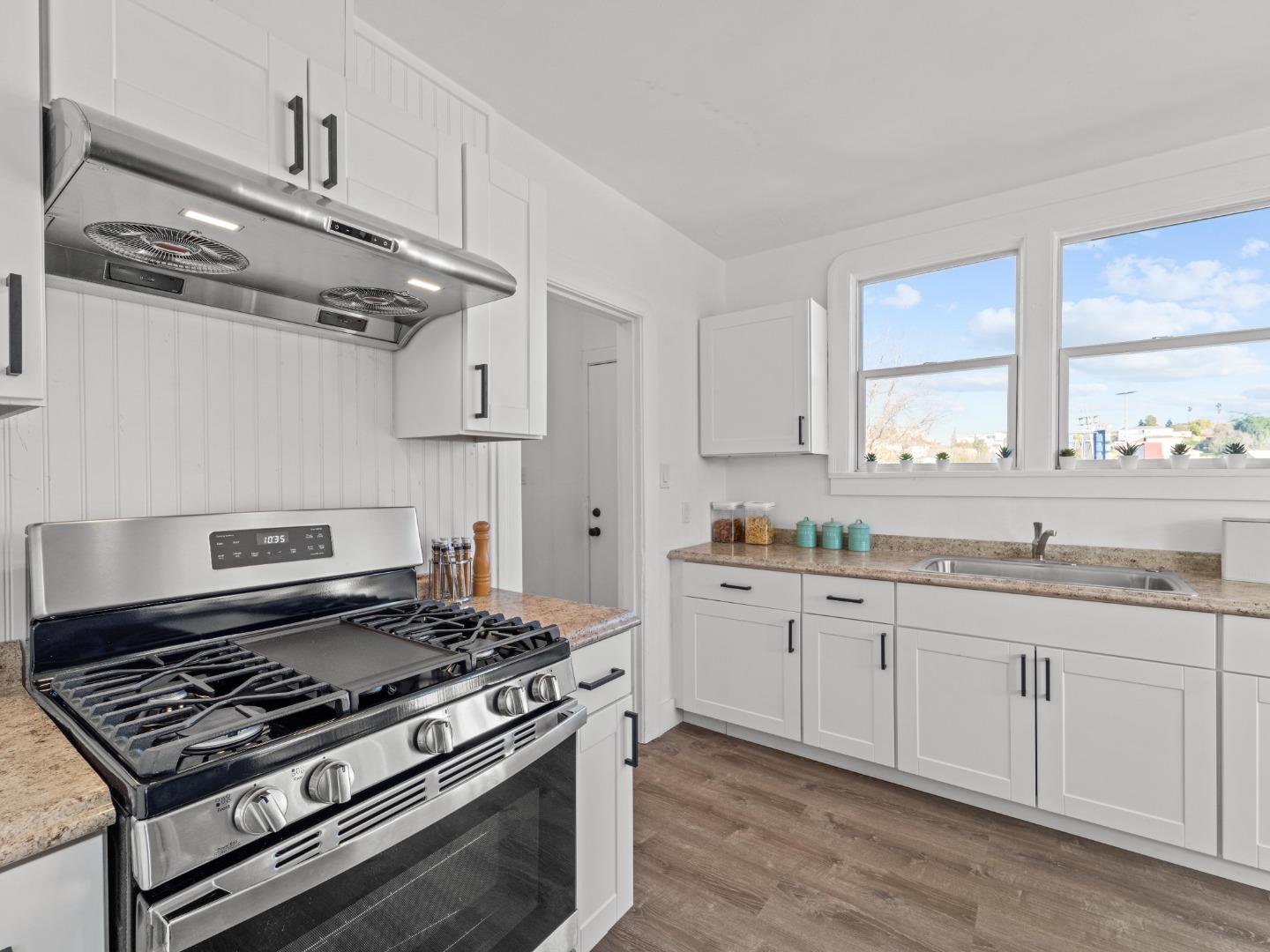 524 Fourth Street Rodeo, CA 94572 - Photo 8 of 36 a kitchen with stainless steel appliances a sink and cabinets