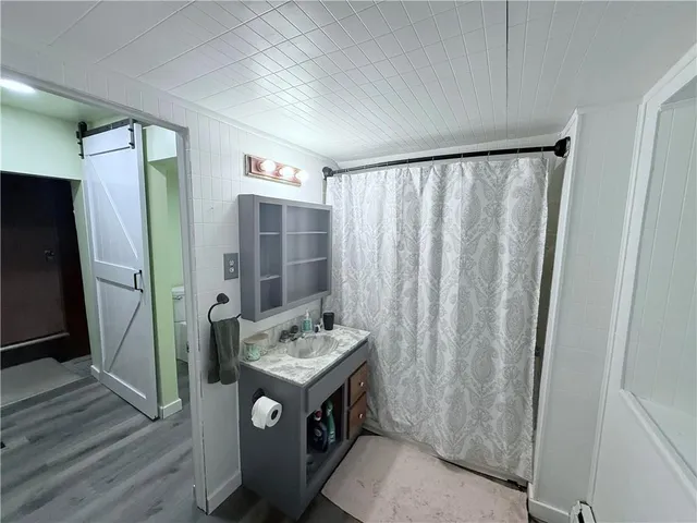 a bathroom with a sink a mirror and a shower