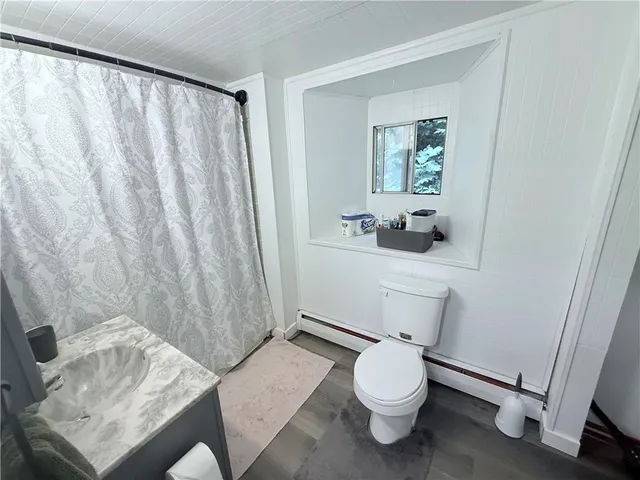 a bathroom with a sink a toilet and tub