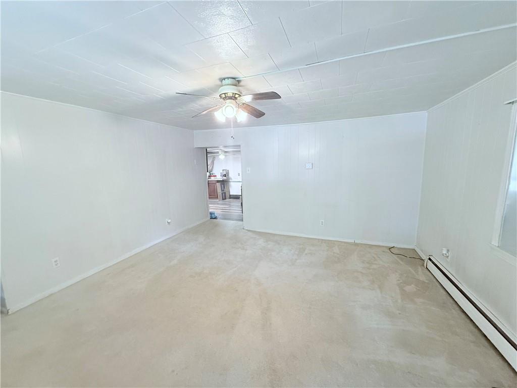 337 Coal Valley Road Clairton, PA 15025 - Photo 20 of 30 an empty room with a chandelier fan and windows