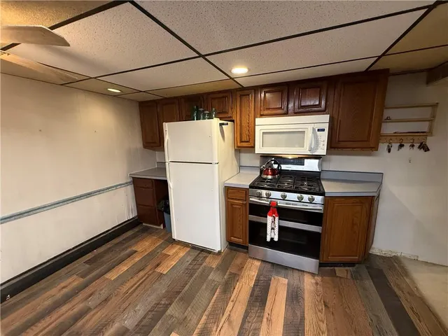 a kitchen with stainless steel appliances granite countertop a refrigerator and a stove