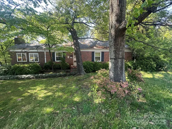 a front view of house with yard and trees