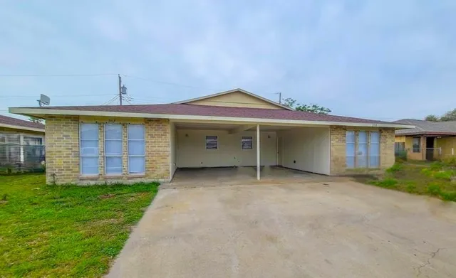 a view of a house with a yard and a garage