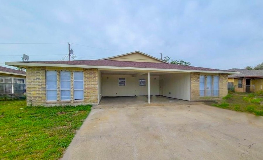 2115 Zephyr Ingleside, TX 78362 - Photo 1 of 10 a view of a house with a yard and a garage