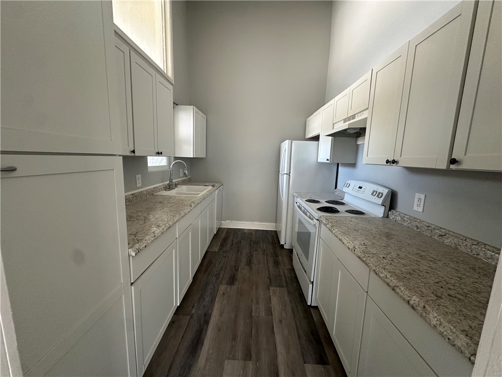 2115 Zephyr Ingleside, TX 78362 - Photo 4 of 10 a kitchen with granite countertop sink stainless steel appliances and cabinets