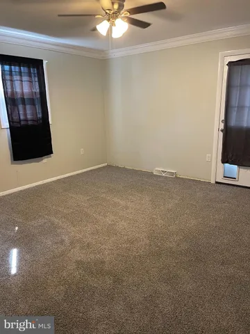 a view of a room with wooden floor