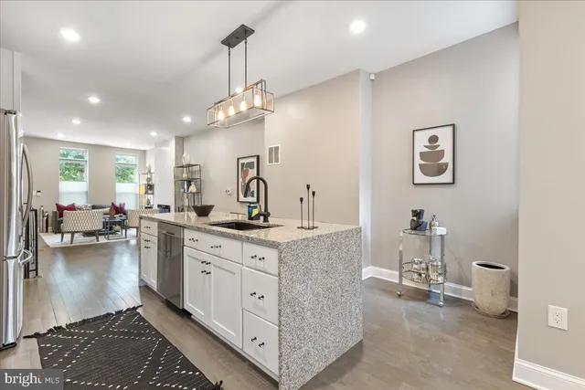 a large white kitchen with a large window