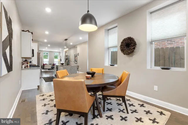 a view of a dining room with furniture and a chandelier