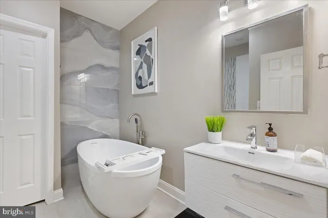 a bathroom with a sink mirror and toilet