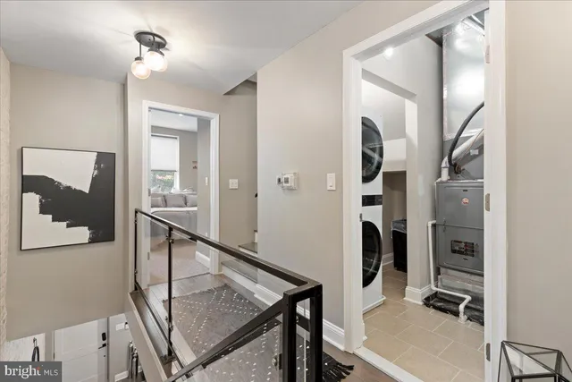 a view of a hallway with workspace and mirror
