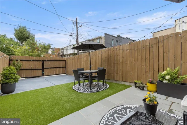 a view of a patio with a table and chairs