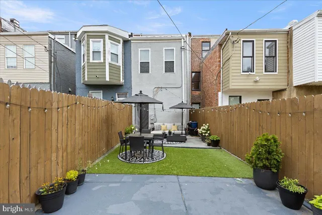 a backyard of a house with yard and outdoor seating