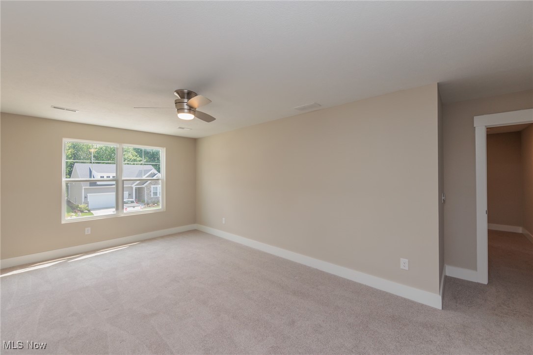 36458 Appian Way North Ridgeville, OH 44039 - Photo 25 of 37 Empty room with light colored carpet and ceiling fan
