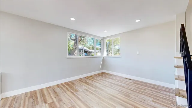 a kitchen with stainless steel appliances granite countertop a stove a sink and white cabinets