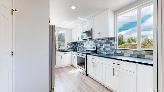 a kitchen with stainless steel appliances a refrigerator and a sink