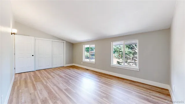 a view of a room with wooden floor