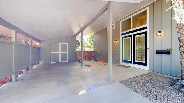 an aerial view of a house with a yard and large trees