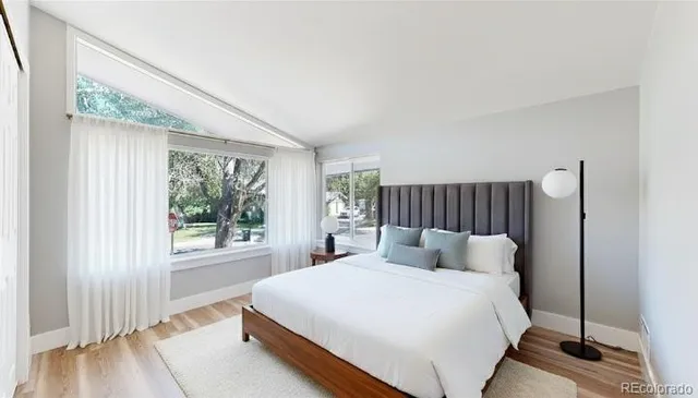 a bedroom with furniture and a book shelf