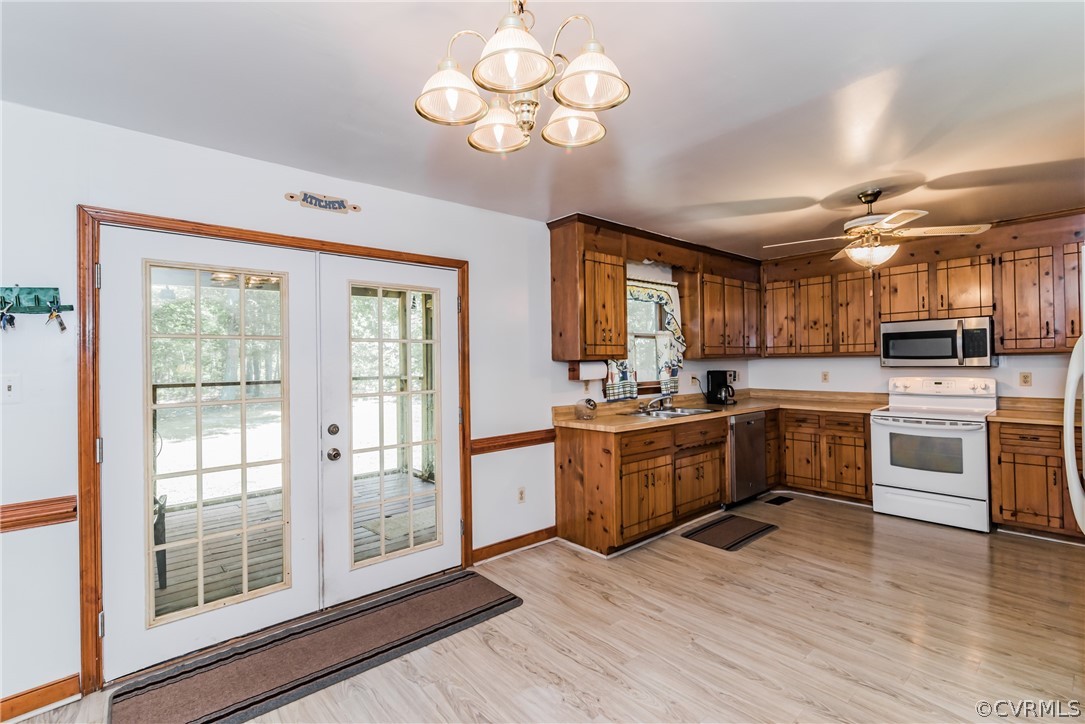 12720 River Road Chesterfield, VA 23838 - Photo 11 of 33 a large kitchen with cabinets wooden floor and stainless steel appliances