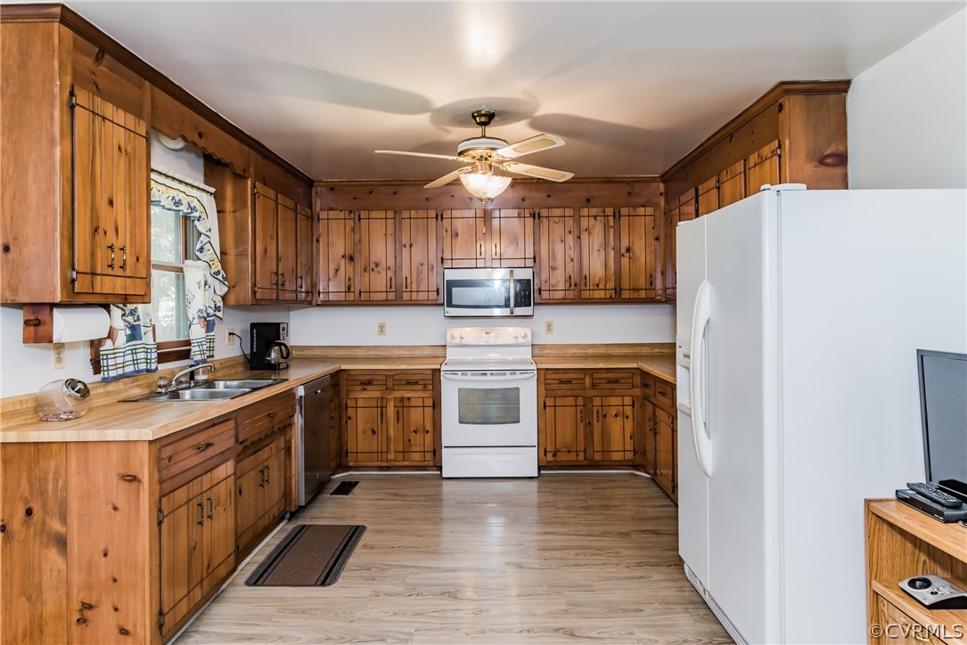 12720 River Road Chesterfield, VA 23838 - Photo 13 of 33 a kitchen with stainless steel appliances granite countertop a stove top oven a refrigerator a sink and dishwasher with wooden floor