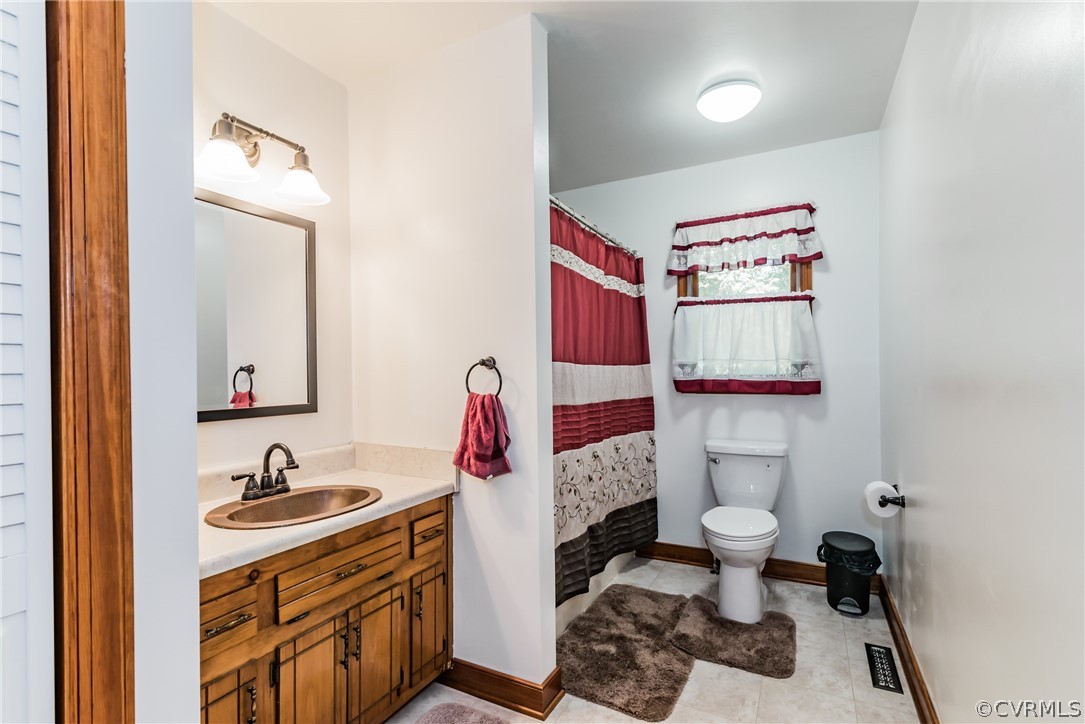 12720 River Road Chesterfield, VA 23838 - Photo 19 of 33 a bathroom with a sink and a mirror
