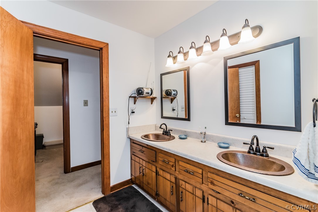 12720 River Road Chesterfield, VA 23838 - Photo 26 of 33 a bathroom with a double vanity sink and a mirror