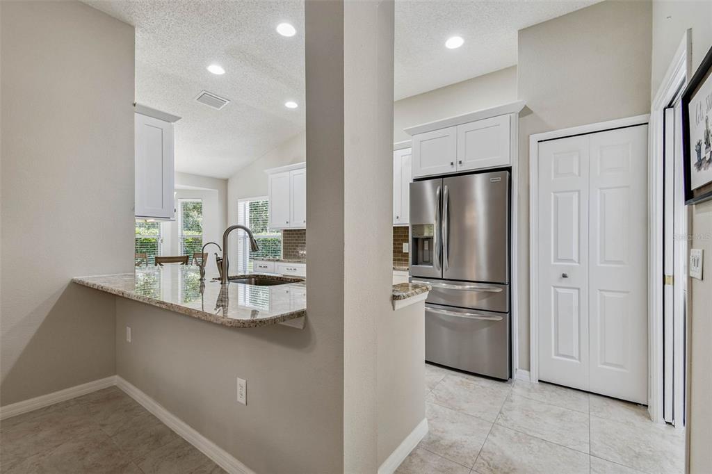 12202 Aaron Terrace Trinity, FL 34655 - Photo 18 of 41 a kitchen with kitchen island a counter top space cabinets and stainless steel appliances
