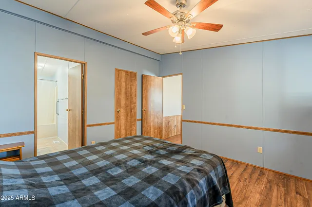 a bedroom with a large bed and a chandelier