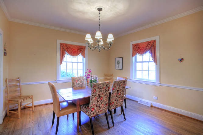 1454 Rugby Road Charlottesville, VA 22903 - Photo 14 of 33 a dining room with furniture a chandelier and wooden floor