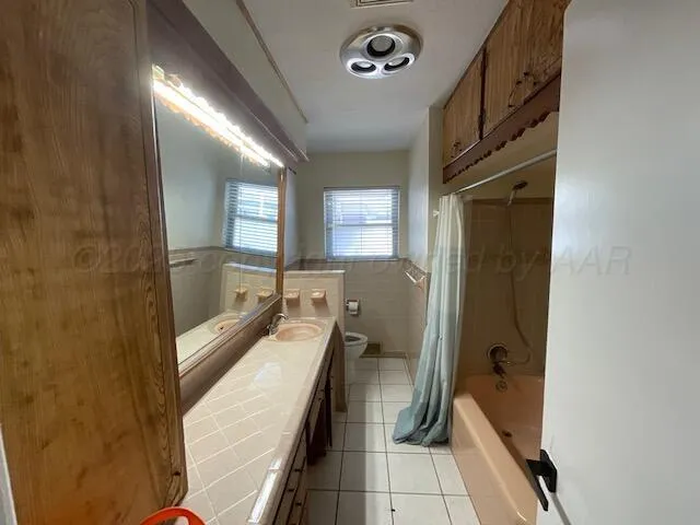 a bathroom with a tub shower and sink