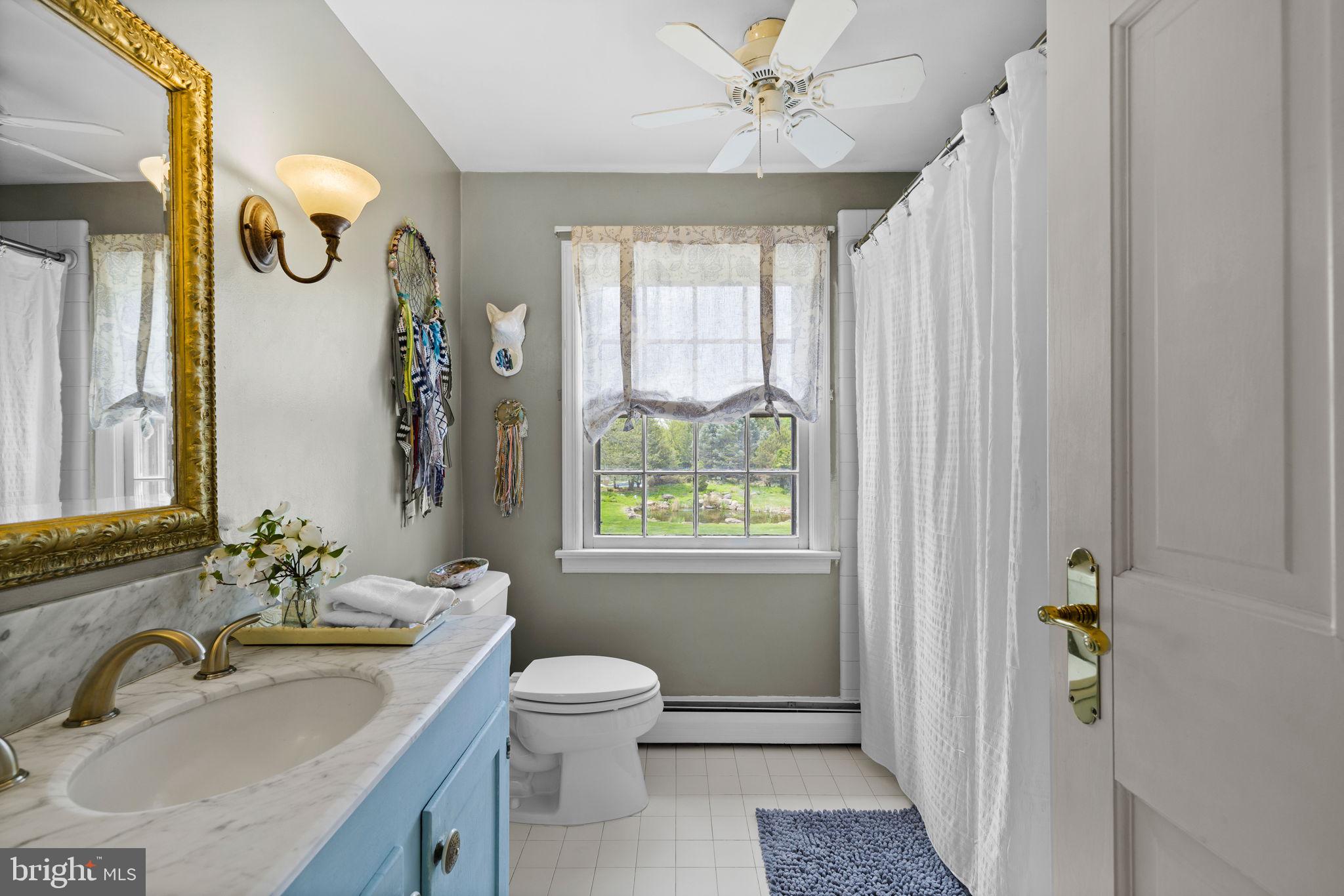 65 Covered Bridge Road New Hope, PA 18938 - Photo 17 of 117 a bathroom with a sink a toilet and a window