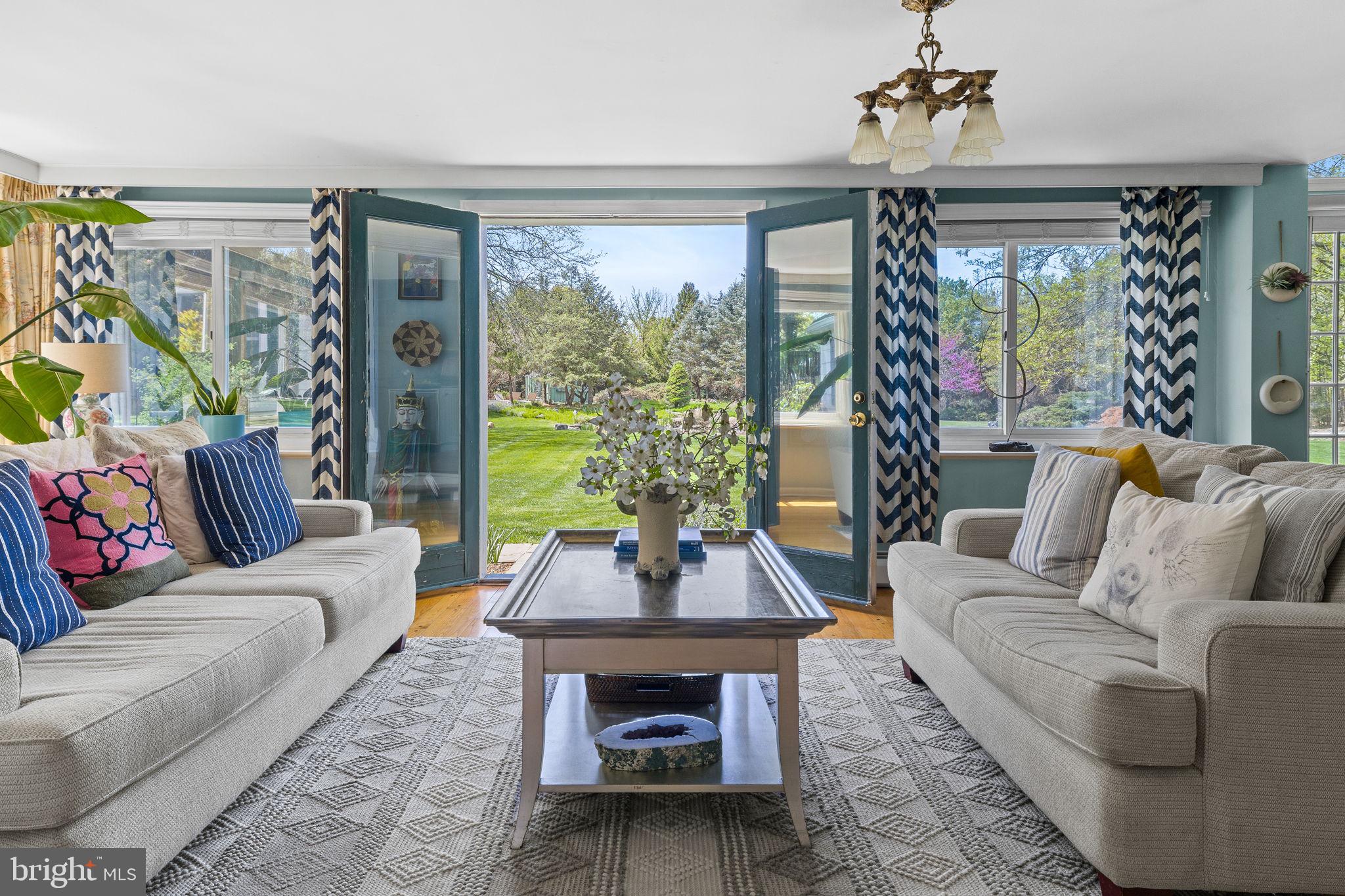 65 Covered Bridge Road New Hope, PA 18938 - Photo 29 of 117 a living room with furniture a chandelier and a large window