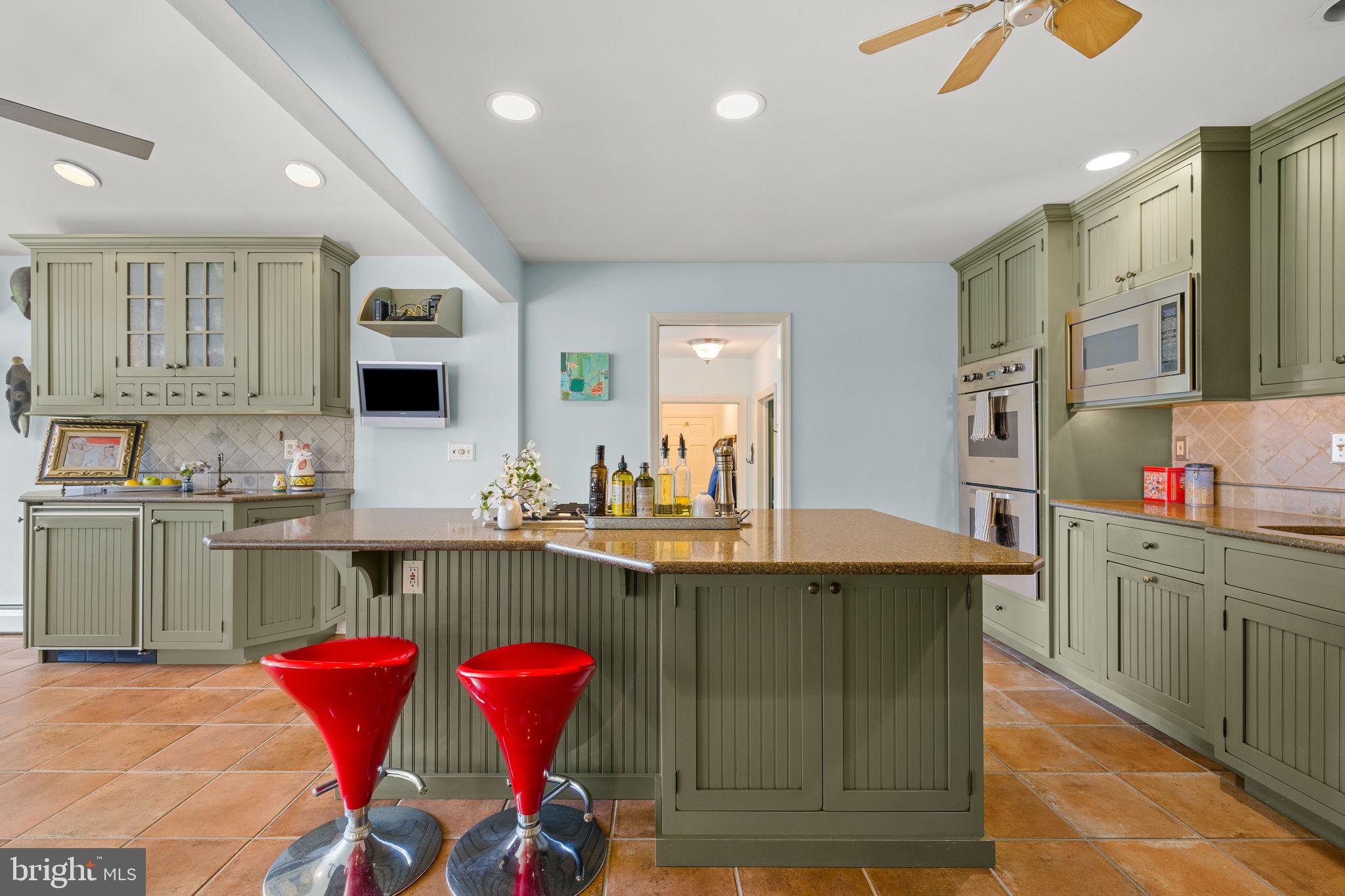 65 Covered Bridge Road New Hope, PA 18938 - Photo 46 of 117 a kitchen with stainless steel appliances granite countertop a sink dishwasher and cabinets with wooden floor