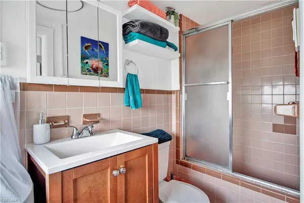 a bathroom with a sink toilet and shower