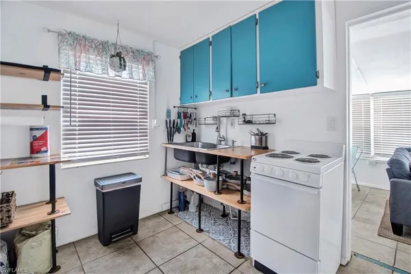 a kitchen with cabinets and window