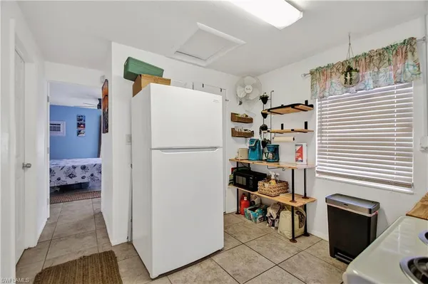a kitchen with refrigerator and cabinets