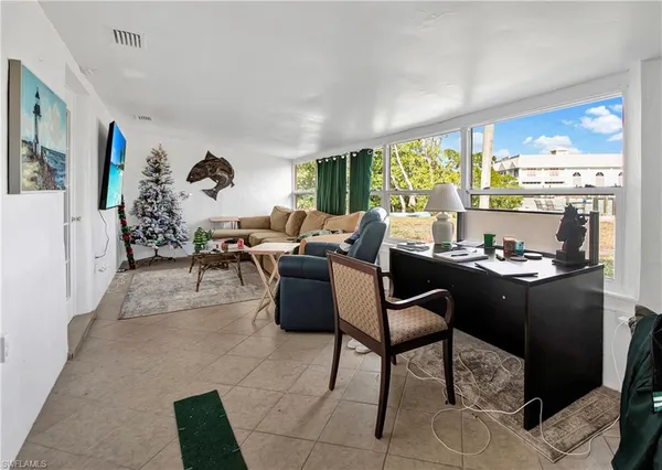 a living room with furniture and a large window
