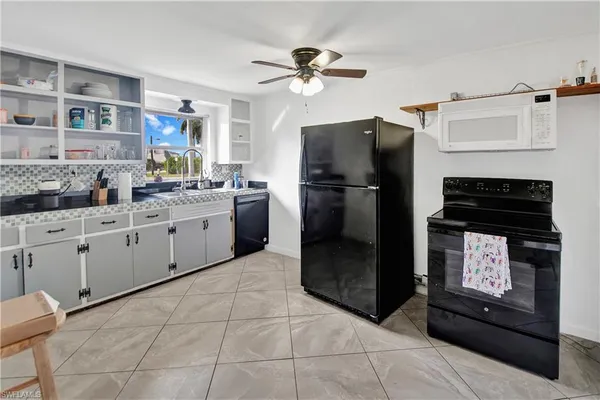 a kitchen with a refrigerator and a stove top oven