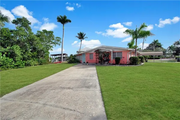 a front view of house with yard and green space