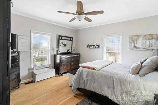 a bedroom with a bed dresser and a window