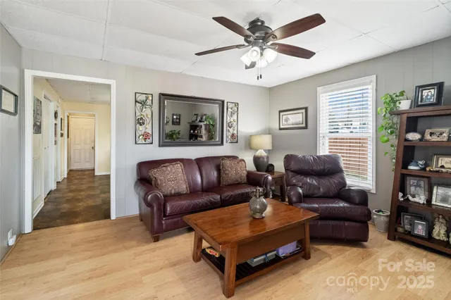 a living room with furniture and a book shelf