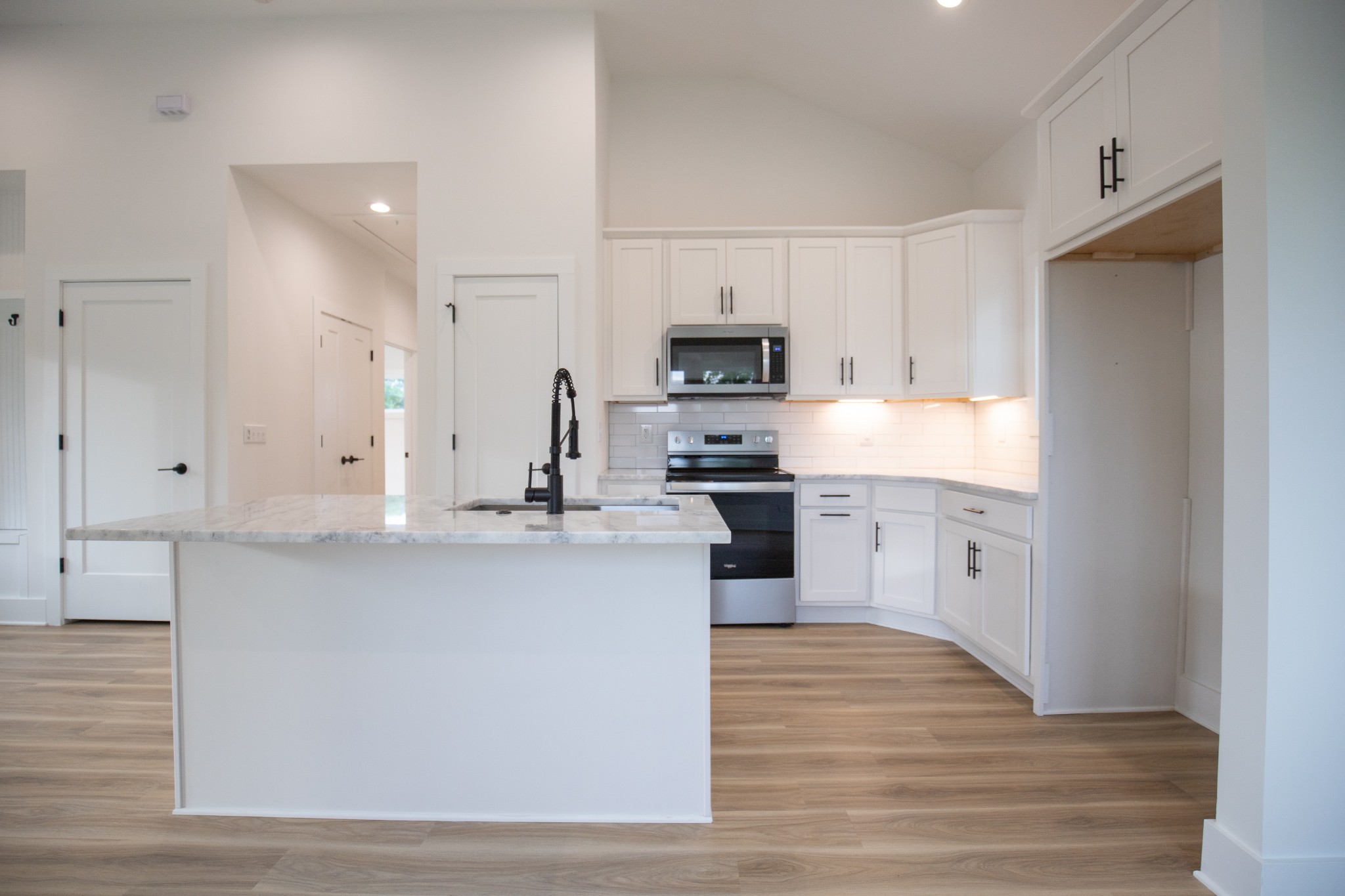 308 Larkin Springs Road Madison, TN 37115 - Photo 13 of 25 a kitchen with kitchen island white cabinets and stainless steel appliances